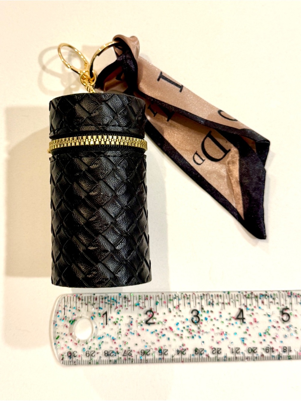 Black Quilted Mini Cylinder Bag Charm with Gold Zip and Scarf Accent, Unbranded.